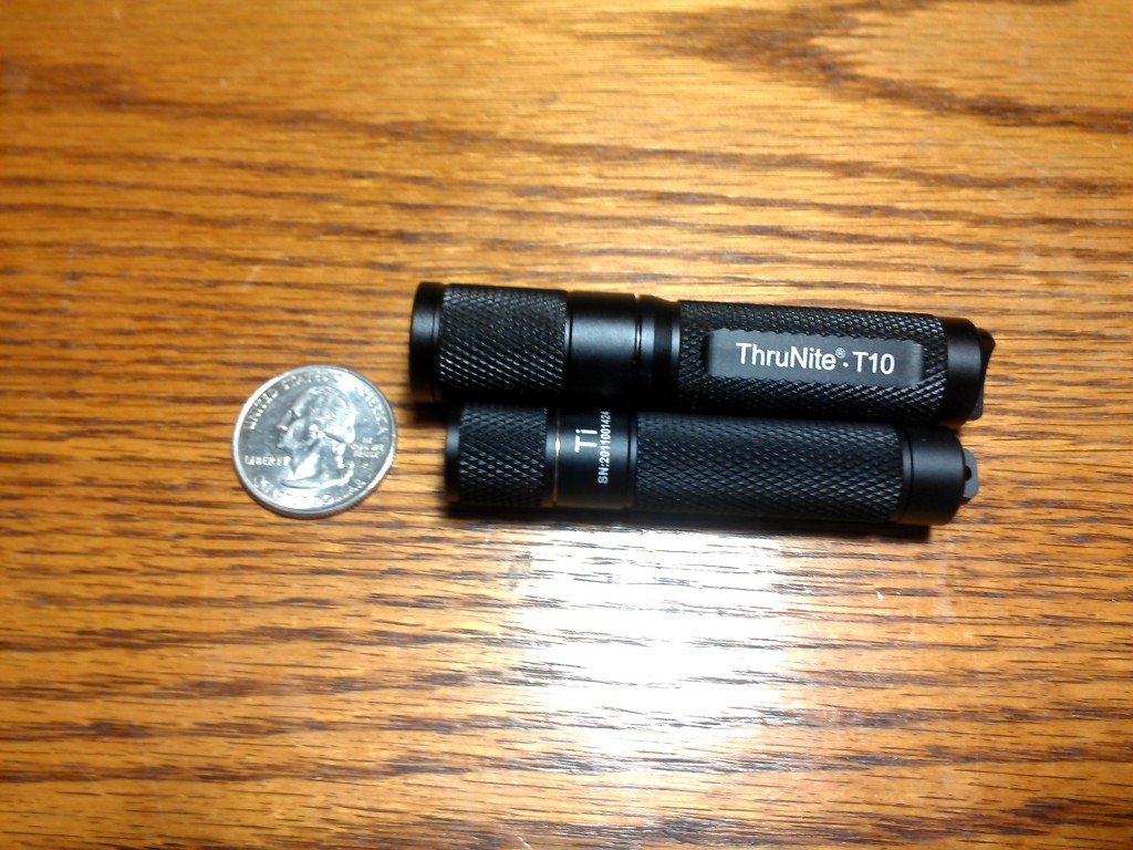 ThruNite T10 and Ti flashlights, with a quarter for scale.