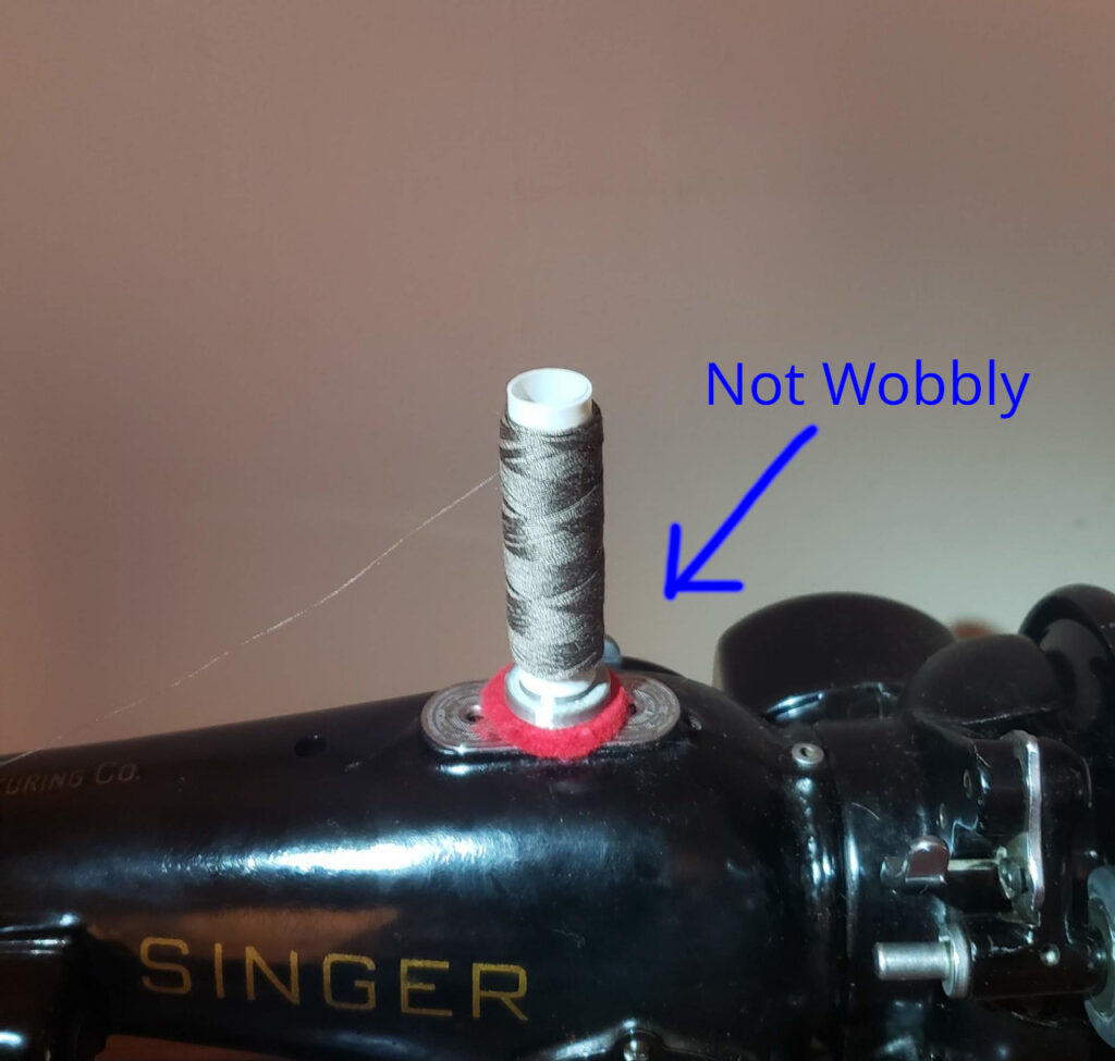 Showing the part installed between the tube and spool pin.