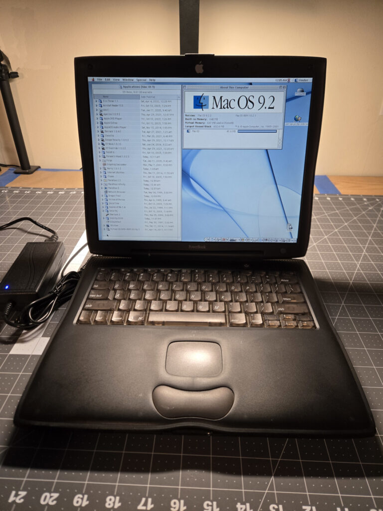 Picture of a running Pismo Powerbook, showing the "About this Mac" page and list of installed Applications