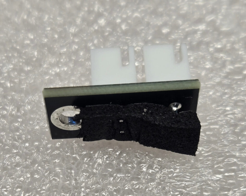 Pins poking through the foam insulation on a fan adapter.  Trim them, it caused a short.